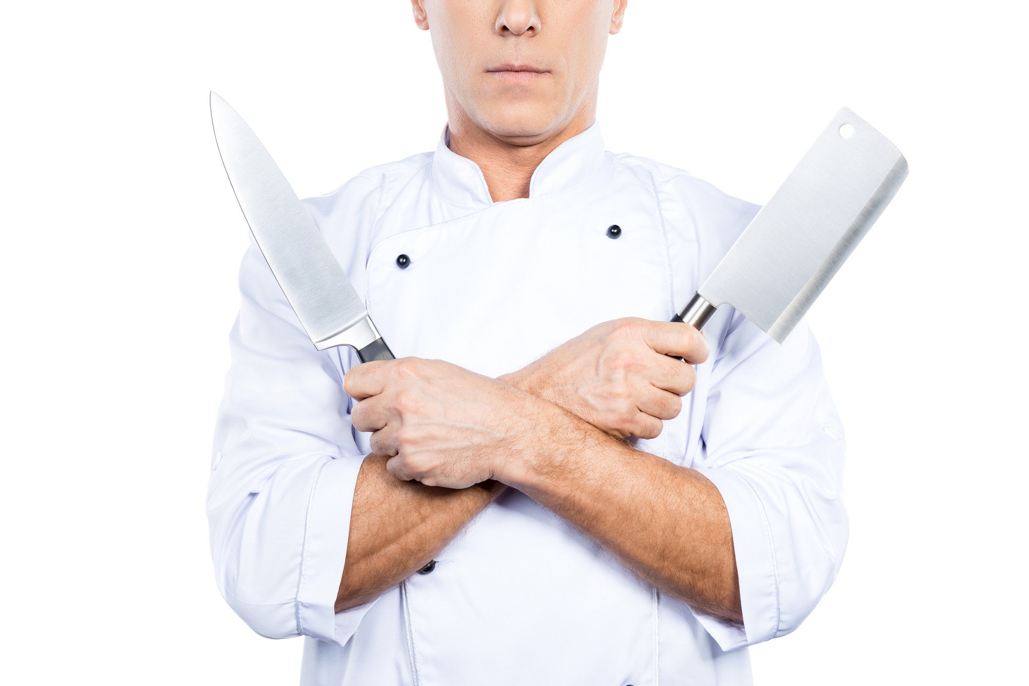 Instructor demonstrating knife technique in bright studio kitchen